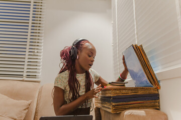 A black woman looking through vinyls