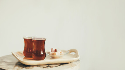 Turkish tea and dessert on a tray on white background.