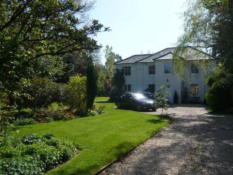 Two Cars Parked On A Country House Driveway, Burley, New Forest, Hampshire, England, UK