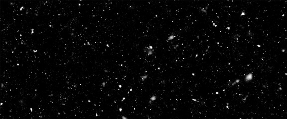 Falling snow isolated on black background. Falling snow at night. Bokeh lights on black background, flying snowflakes in the air. Winter weather. Overlay texture.