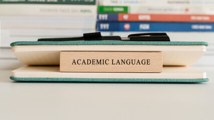 Academic Language writing on wooden surface. Book and wood concept. Education and work. © Caner