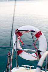 Yacht accessories, lifebuoy on the stern of the yacht. Vertical photo.
