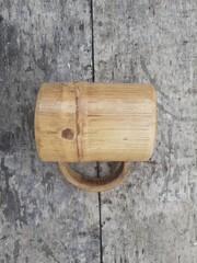 Indonesian bamboo art crafts. Homemade, Indonesian traditional bamboo. Bamboo glass handicrafts. Wooden background. Top view.