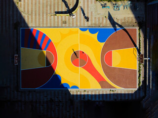 A child playing at the colorful basketball court