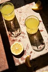 Traditional italian homemade lemon alcohol drink liqueur limoncello with pieces of lemon