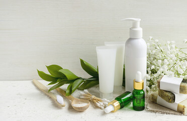 Eco cosmetic products for skin care of face and body. White tubes with natural creams, soap,...