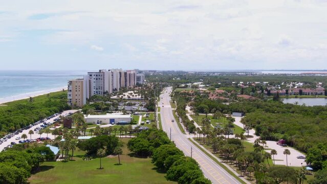 Slow aerial descent towards highway on Florida east coast