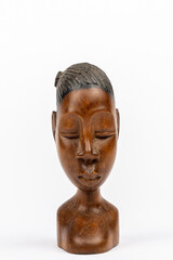 Wooden figurine of an African woman isolated on white background, front view