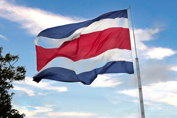Costa Rican flag waving in the wind on sunny day. 