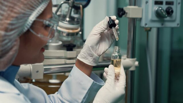 Scientist test CBD hemp oil product in curative CBD lab . The hemp oil contain natural cbd extraction from organic hemp in the farm .