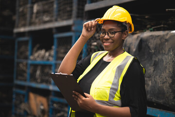 black African woman worker work in metal heavy industry machine factory as engineer team standing...