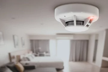 Fotobehang smoke detector fire alarm detector home safety device setup at home hotel room ceiling © Quality Stock Arts