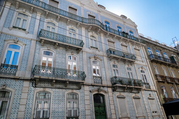 Typical architecture of the capital Lisbon city streets and people.