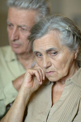 Portrait of a elderly couple being sad together