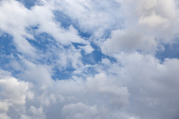 Beautiful blue sky with many white clouds shaped like cotton flowers