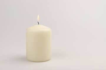 Fototapeta na wymiar Burning white wax candles on white background.