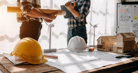 Construction team shake hands greeting start new project plan behind yellow helmet on desk in...