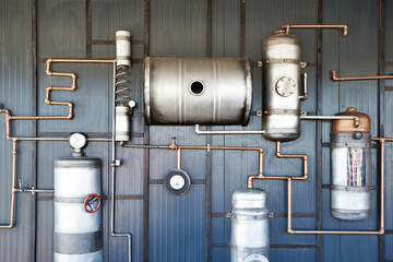 Vintage steampunk installation of pipes and metal barrels