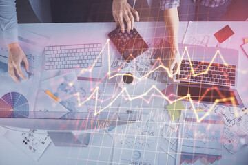 Multi exposure of man and woman working together and financial chart hologram. Business concept. Computer background.