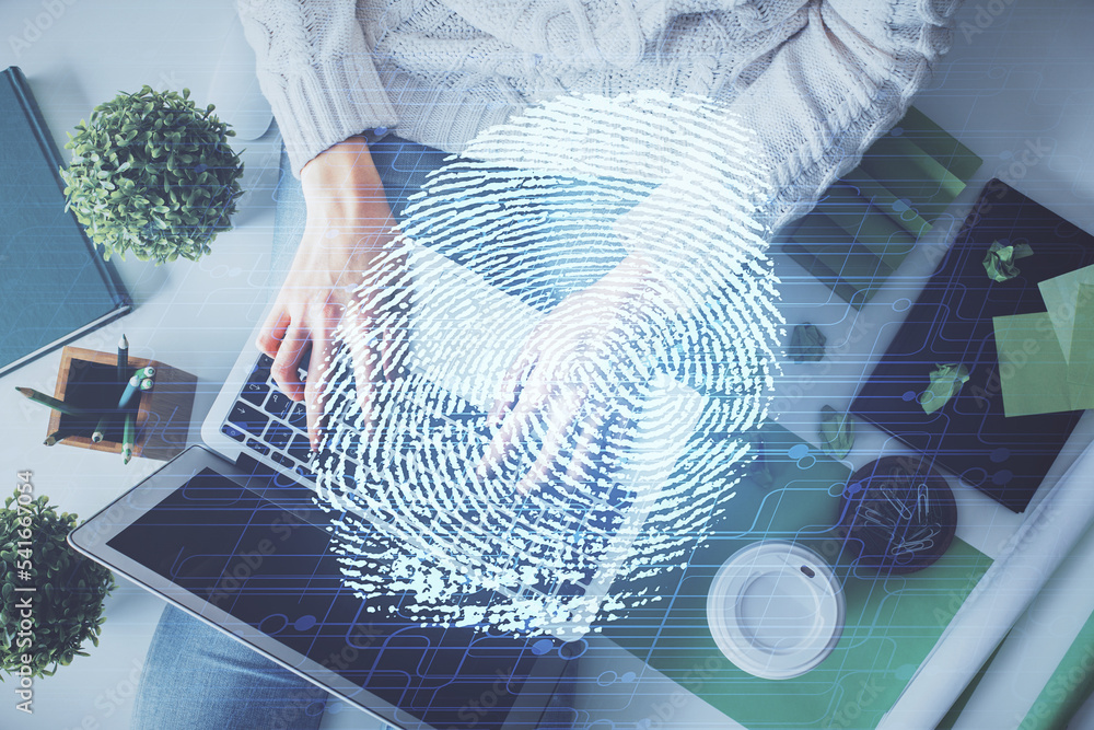 Poster Double exposure of woman hands working on computer and fingerprint hologram drawing. Top View. Digital Security concept.