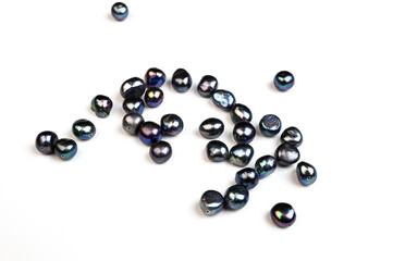 Baroque pearls. Natural freshwater black pearl beads on white background. Close up