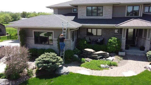 Drone push in on a home improvement crew getting out of a truck with tools.