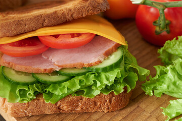 A sandwich close-up on a wooden background.