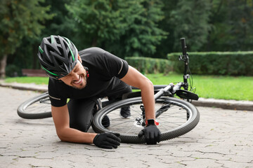 Man fallen off his bike in park