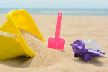 Fototapeta na wymiar Set of colorful beach toys on sand near sea, closeup