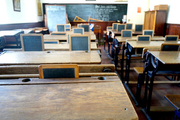 Old wooden desks in an old style classroom
