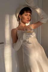 Mobile photo of a young woman with a glass of champagne - 541674686