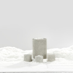 Stone pedestal in snow and winter background. 