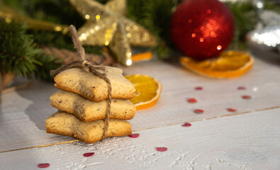 Ginger cookies, spruce branches and Christmas balls, on a white wooden background
