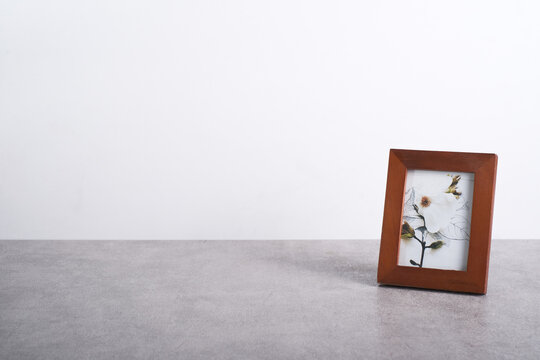 Photo frame on a gray surface with white background