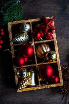 Overhead view of assorted Christmas baubles in a wooden box