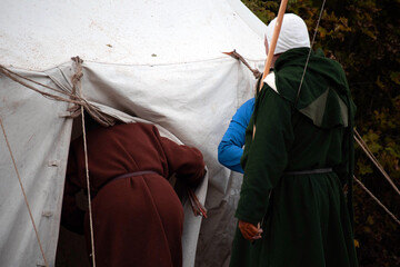 The monks enter the white tent. Medieval concept