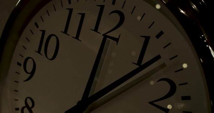 Timelapse shot of a clock face losing light as time passes