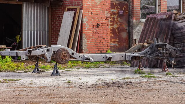 Rusted Vehicle Chassis Being Painted With Primer Paint By Skilled Workers Outdoor. timelapse