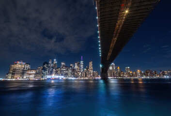 View of New York City - beautiful landscape, from Brooklyn Bridge Park, waterfront at night over bridge