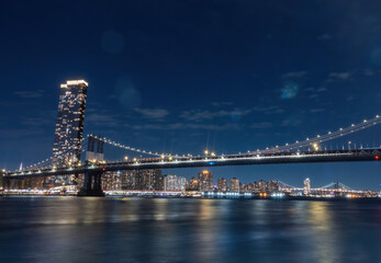 View of New York City - beautiful landscape, Manhattan Bridge, waterfront at night over bridge