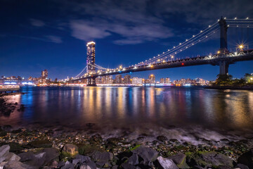 View of New York City - beautiful landscape, Manhattan Bridge, waterfront at night over bridge