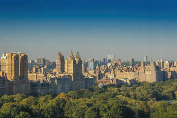 Fototapeta na wymiar Aerial view of the Central park in Manhattan, New York with golf fields and tall skyscrapers surrounding the park. Sunset view.