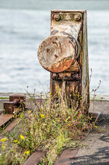 Train-stopping element at the end of an old and overgrown railway track on a quay in the harbour of Rotterdam, The Netherlands
