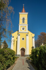 Medieval Saint Martin Roman Catholic Church with the stone cross in front on Kossuth Lajos way in...