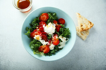 Kale salad with fresh cheese and strawberry