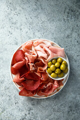 Traditional meat platter with green olives