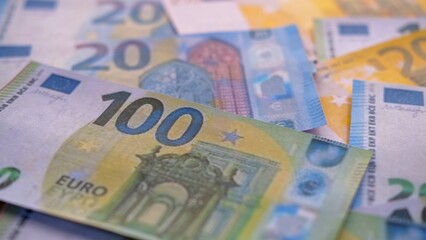 Euros on a pile of European currencies, European inflation, European economic recession, economics and finance concept