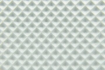 White foamlike square texture with small grooves and dirt