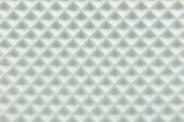 White foamlike square texture with small grooves and dirt