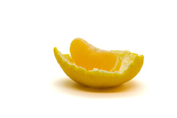 Fototapeta na wymiar Single yellow slice of satsuma orange (Citrus unshiu) on a part of peel isolated on white background